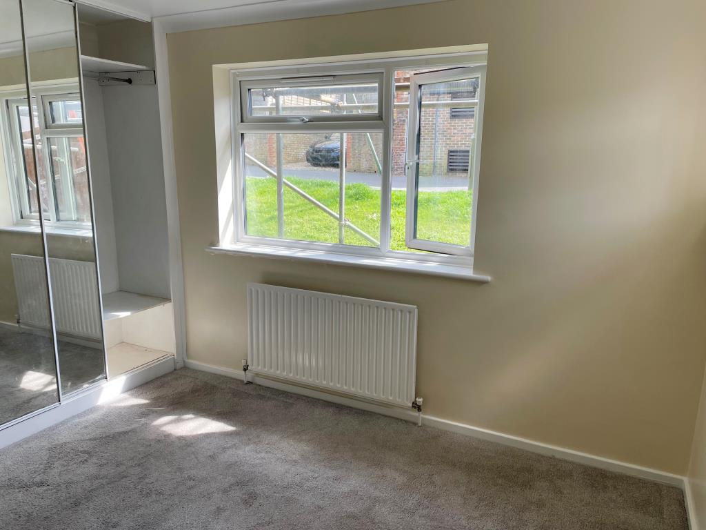 Lot: 151 - TWO-BEDROOM FLAT WITH PARKING - main bedroom at front with fitted wardrobes and window